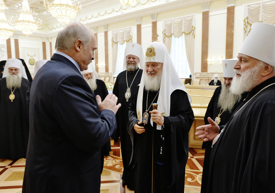 Belarusian President Alexander Lukashenko, second from left, and Russian Orthodox Church Patriarch Kirill, second from right, during their meeting with members of the Russian Orthodox Church Holy Synod and Belarusian Orthodox Church Synod in Minsk, Belarus, Monday, Oct. 15, 2018. (Igor Palkin, Russian Orthodox Church Press Service via AP)
