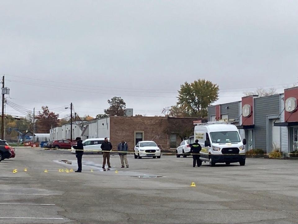 Investigators continue to process the scene on East 65th Street in Indianapolis following a shooting early Sunday morning that left a woman dead and nine other young people injured.