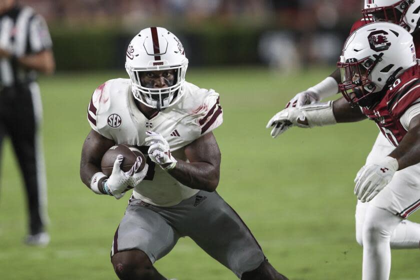 Mississippi State running back Jo'Quavious Marks tries to avoid South Carolina defensive end Tyreek Johnson on Sept. 23