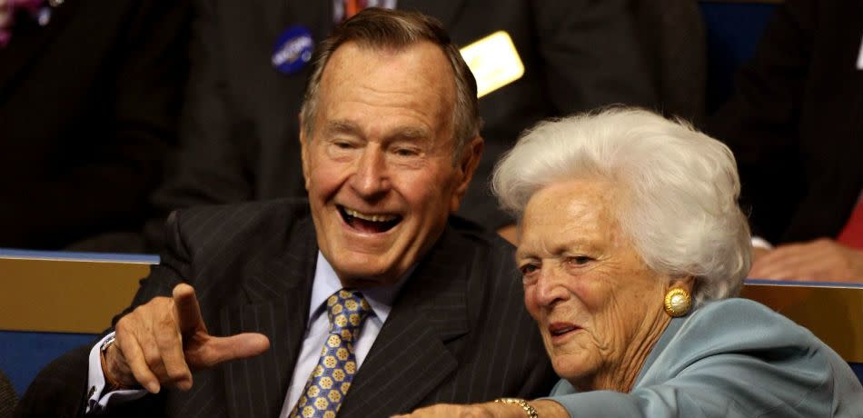 George H.W. and Barbara Bush Point at The Camera.