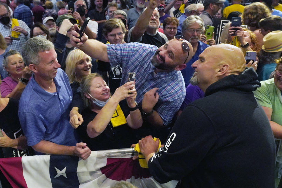 Pennsylvania Lt. Gov. John Fetterman, the Democratic nominee for the state's U.S. Senate seat, right, poses for a photo with a supporter after speaking at a rally in Erie, Pa., on Friday, Aug. 12, 2022. (AP Photo/Gene J. Puskar)