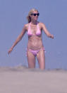 <p>Vacationing close to home is on GP’s “do” list. She’s long been a fixture in the Hamptons, and this is where she was snapped in a pink bikini and black shades in July 2010. But, honestly, it could be any of her vacations, because they all pretty much look the same, so we hope she labels her photos. (Photo: Hypnotics/Splash News) </p>