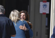 Marianne Campbell Smith, center, is greeted by supporters as she leaves the West Justice Center, Wednesday, Oct. 20, 2021, in Westminster, Calif., during a lunch break in her trial. Smith, who refused to leave a Costa Mesa grocery store, was convicted of trespassing on Wednesday after becoming the only person to go on trial in Orange County for not following pandemic-driven face-covering mandates at local businesses. (Jeff Gritchen/The Orange County Register via AP)