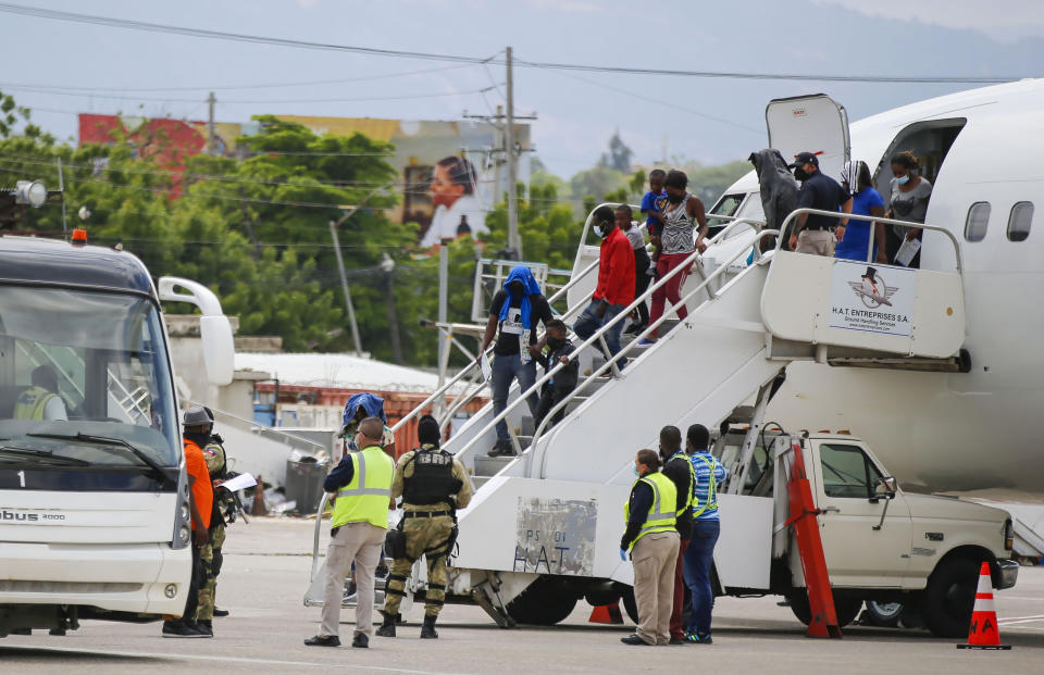 Haitians who were deported from the United States deplane at the Toussaint Louverture International Airport, in Port au Prince, Haiti, Sunday, Sep. 19, 2021. Thousands of Haitian migrants have been arriving to Del Rio, Texas, to ask for asylum in the U.S., as authorities begin to deported them to back to Haiti. (AP Photo/Joseph Odelyn)