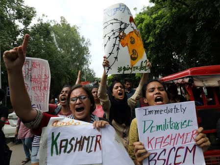 Students display placards and shout slogans during a protest against the scrapping of the special constitutional status for Kashmir by the government, in New Delhi