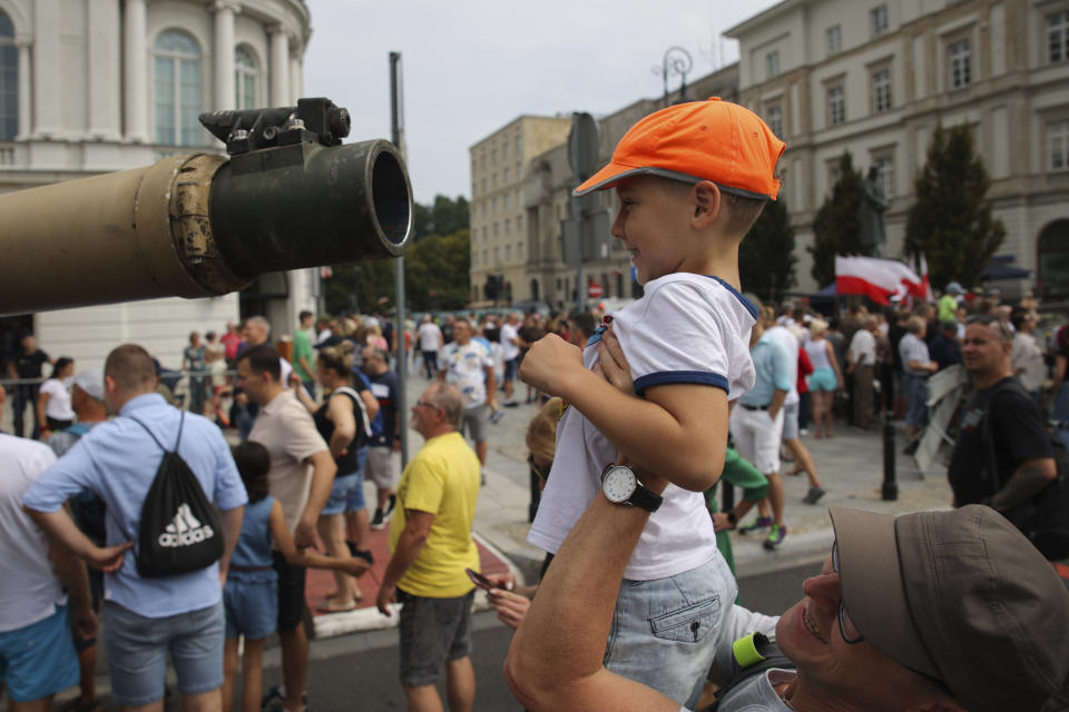 People attend a military picnic marking the Polish Army Day in Warsaw, Poland, Monday, Aug. 15, 2022. The Polish president and other officials marked their nation's Armed Forces Day holiday Monday alongside the U.S. army commander in Europe and regular American troops, a symbolic underlining of NATO support for members on the eastern front as Russia wages war nearby in Ukraine. (AP Photo/Michal Dyjuk)