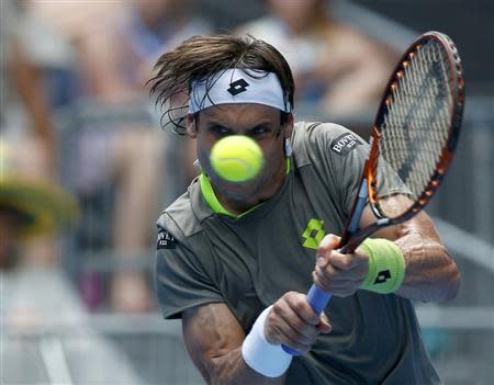 David Ferrer of Spain hits a return to Adrian Mannarino of France at the Australian Open 2014 tennis tournament in Melbourne January 15, 2014. REUTERS/Bobby Yip