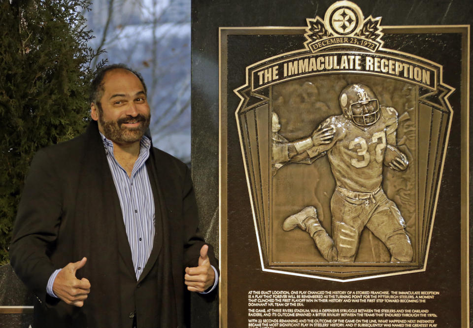 FILE - Hall of Fame running back, Pittsburgh Steelers' Franco Harris stands on the spot of the "Immaculate Reception" after a marker commemorating the 40th anniversary of the play was unveiled where Three Rivers Stadium once stood on the Northside of Pittsburgh, Saturday, Dec. 22, 2012. Franco Harris, the Hall of Fame running back whose heads-up thinking authored “The Immaculate Reception,” considered the most iconic play in NFL history, died Wednesday, Dec. 21, 2022. He was 72. (AP Photo/Gene J. Puskar, File)