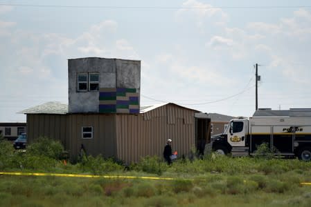 FBI agents investigate the home of Seth Ator following a shooting in Odessa