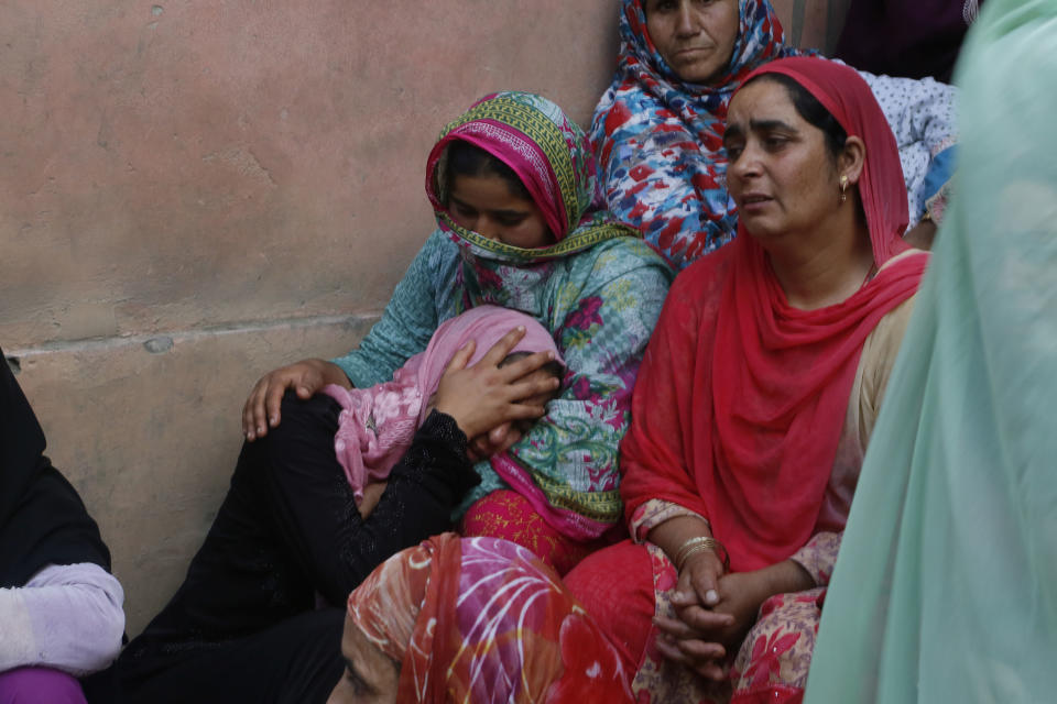 Relatives mourn during the funeral of slain policeman Adil Ahmad at Zaura village, about 62 kilometers south of Srinagar, Indian controlled Kashmir, Wednesday, Aug. 29, 2018. Rebels fighting against Indian rule ambushed a group of police officers and killed four of them, including Ahmad, on Wednesday in the disputed Himalayan region of Kashmir, police said. (AP Photo/Mukhtar Khan)