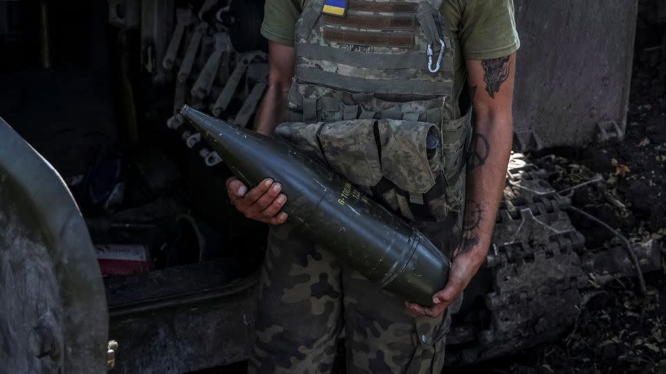 A Ukrainian serviceman holds an artillery shell as he stands near a self-propelled howitzer before firing towards Russian troops in the Donetsk region of Ukraine on September 26. - Oleksandr Ratushniak/Reuters