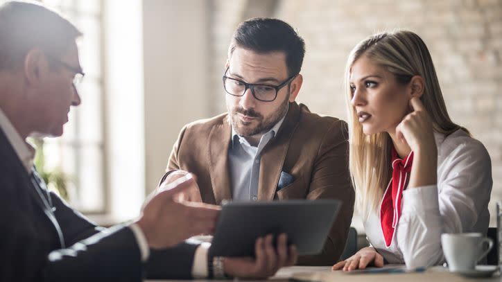 A married couple meets with their financial advisor.