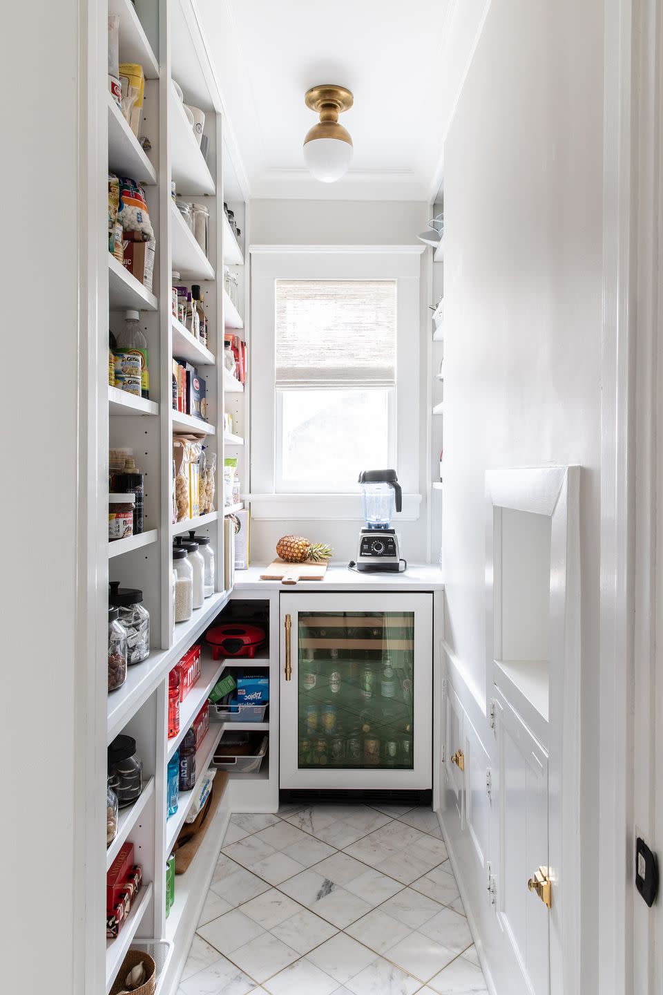 pantry with floor to ceiling shelving and small counter