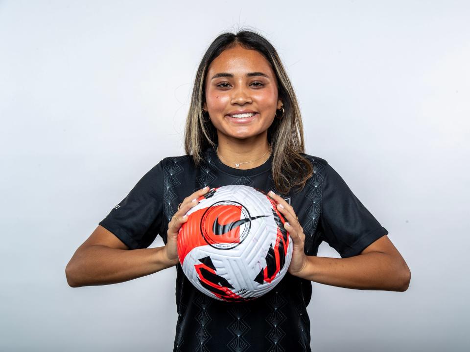 Alyssa Thompson poses with a Nike ball.