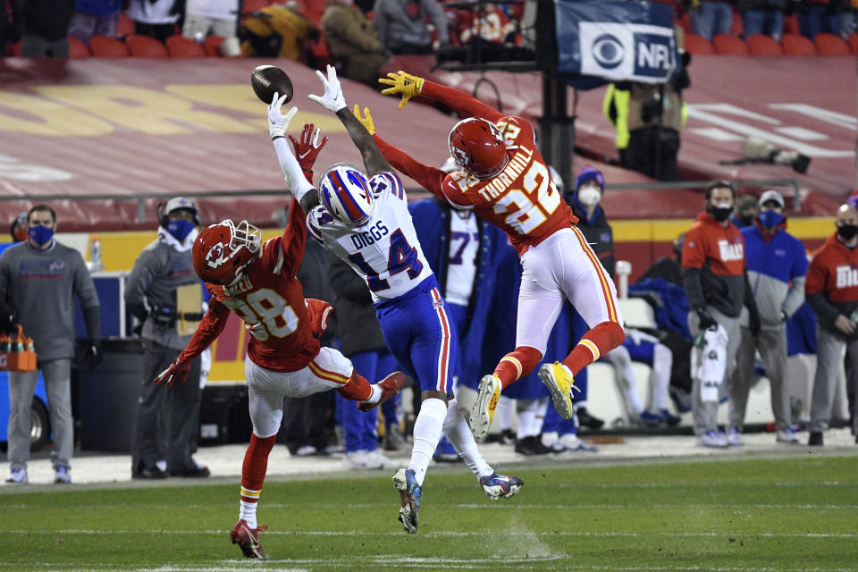 Kansas City Chiefs safety L'Jarius Sneed (38) and safety Juan Thornhill (22) break up pass intended for Buffalo Bills wide receiver Stefon Diggs (14) during the second half of the AFC championship NFL football game, Sunday, Jan. 24, 2021, in Kansas City, Mo. (AP Photo/Reed Hoffmann)