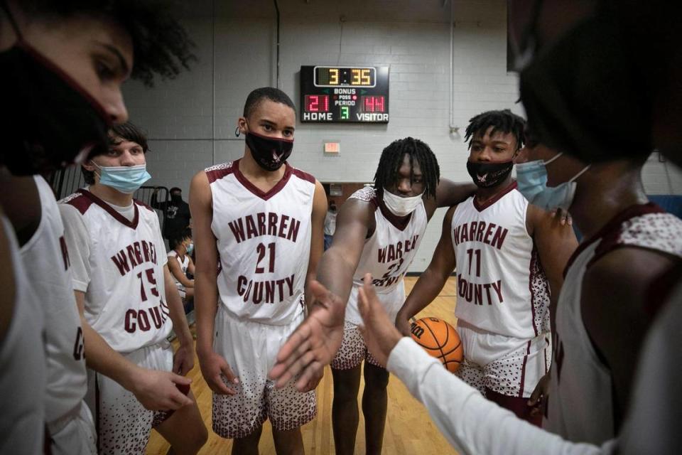 Warren County’s Jaylen Canty (23) reaches in to unify his teammates as they huddle during the third quarter against Webb High School on Friday, January 29, 2021 in Warrenton, N.C.