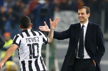 Juventus' Carlos Tevez celebrates with coach Massimiliano Allegri after scoring against AS Roma during their Italian Serie A soccer match at the Olympic stadium in Rome March 2, 2015. REUTERS/Tony Gentile