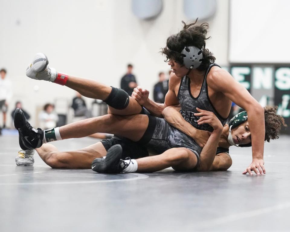 Jensen Beach's Jewell Williams (front) wrestles Treasure Coast's Joey Hartley in a 138 pound match during the Cradle Cancer Invitational high school wrestling tournament Friday, Jan. 7. 2022, at Jensen Beach High School.
