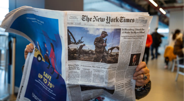 A photo of a person reading the Feb. 16, 2020 issue of the New York Times.