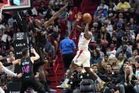 Los Angeles Clippers forward Justise Winslow, right, looks to pass as Miami Heat center Bam Adebayo (13) defends during the first half of an NBA basketball game, Friday, Jan. 28, 2022, in Miami. (AP Photo/Lynne Sladky)