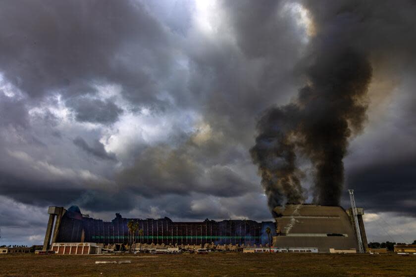 TUSTIN, CA - NOVEMBER 07: A stubborn fire burns a hangar at the former Tustin Air Base Warner on Tuesday, Nov. 7, 2023 in Tustin, CA. (Irfan Khan / Los Angeles Times)