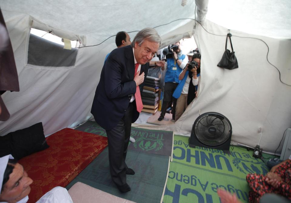 FILE - In this June 20, 2015 file photo, United Nations High Commissioner for Refugees Antonio Guterres enters a family's tent during a visit to the Midyat refugee camp in Mardin, southeastern Turkey, near the Syrian border. Guterres takes the reins of the United Nations on New Year's Day, promising to be a "bridge-builder" but facing an antagonistic incoming U.S. administration led by Donald Trump who thinks the world body's 193 member states do nothing except talk and have a good time. (AP Photo/Emrah Gurel, File)