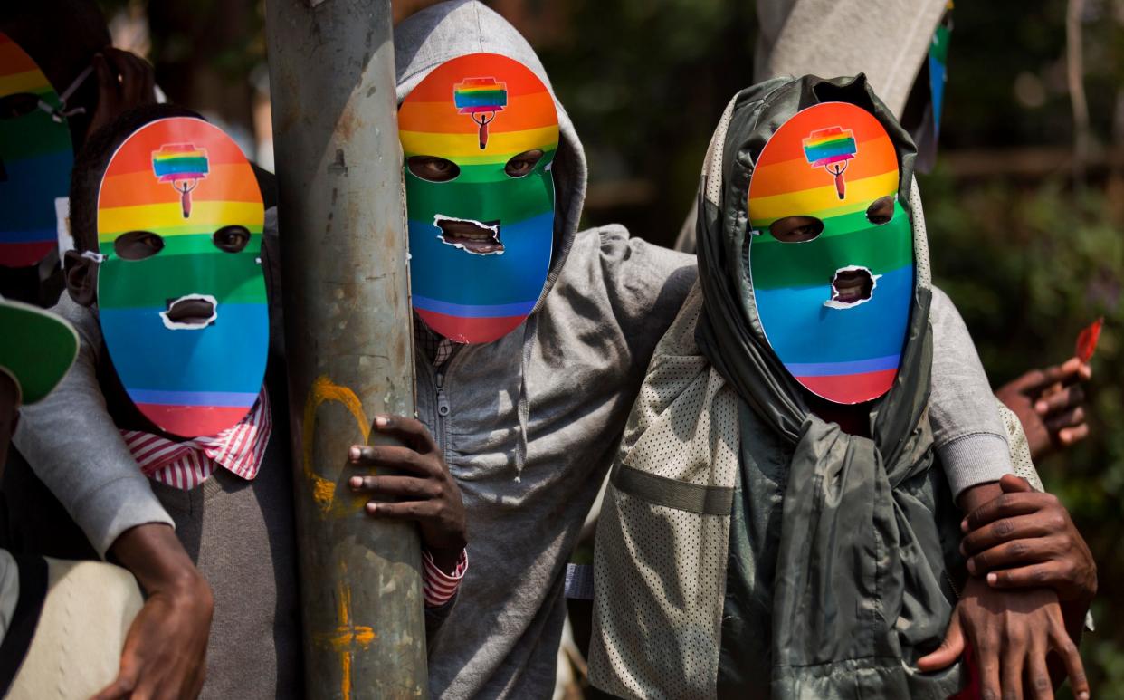 Kenyan gays and lesbians and others supporting their cause wear masks to preserve their anonymity as they stage a rare protest against Uganda's tough stance against homosexuality and in solidarity with their counterparts there, outside the Uganda High Commission in Nairobi, Kenya - Ben Curtis/AP