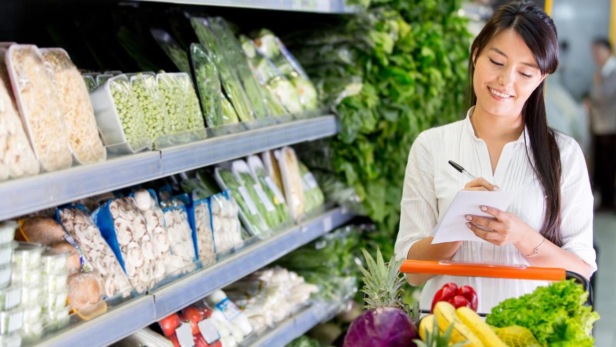 woman grocery shopping with a list