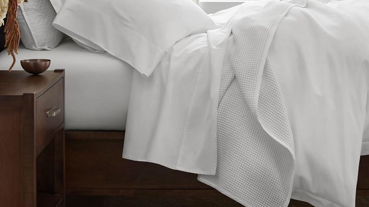 a bed with white sheets