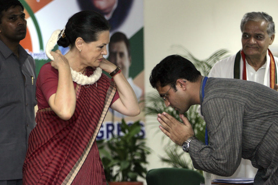 FILE - In this Wednesday, July 26, 2006, file photo, Indian Youth Congress President Ashok Tanwar, right, greets Congress party President Sonia Gandhi at a three day national training conference of congress party district presidents, in New Delhi, India. India's main opposition Congress party appears to be drifting rudderless as it faces a crucial political test in two key state elections in October, 2019, after a severe drubbing at the hands of Prime Minister Narendra Modi’s Hindu nationalist party in the May national elections. Tanwar, Haryana state party chief where voting will be held on Oct. 21, quit following difference with party’s leadership over choice of candidates for voting districts. (AP Photo/Manish Swarup, File)