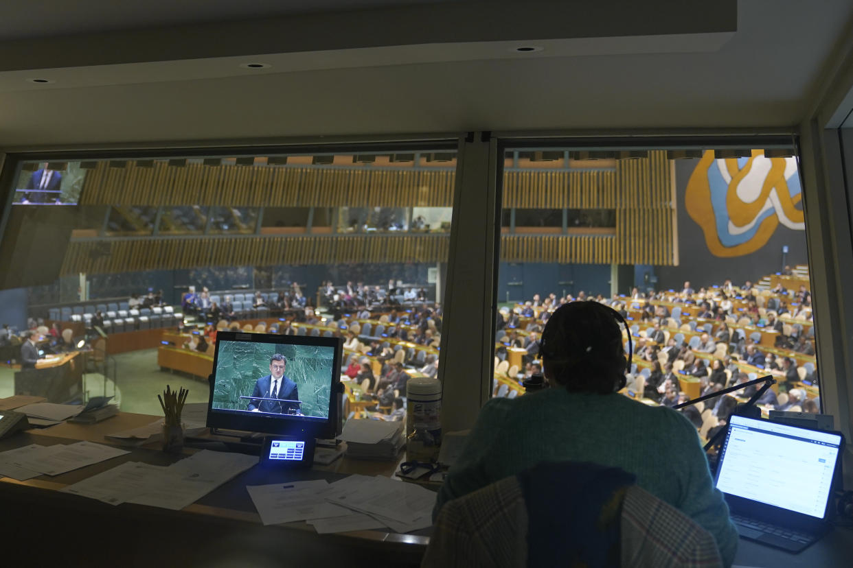 Ukrainian Foreign Minister Dmytro Kuleba is seen on a television screen in a translators booth as he addresses the eleventh emergency special session of the General Assembly, Wednesday, Feb. 22, 2023 at United Nations headquarters. (AP Photo/Mary Altaffer)