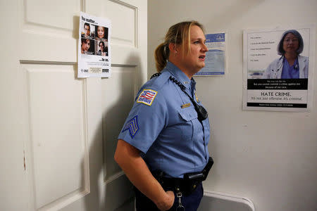 Washington Metropolitan Police Department Sergeant Jessica Hawkins, a transgender woman who leads the department's lesbian, gay, bisexual and transgender (LGBT) unit, speaks about her work at her office in Washington, U.S. October 10, 2016. REUTERS/Jonathan Ernst