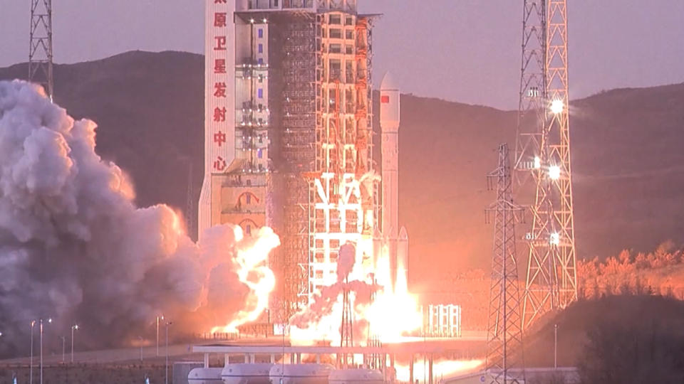 a rocket lifts off at sunset above a plume of fire