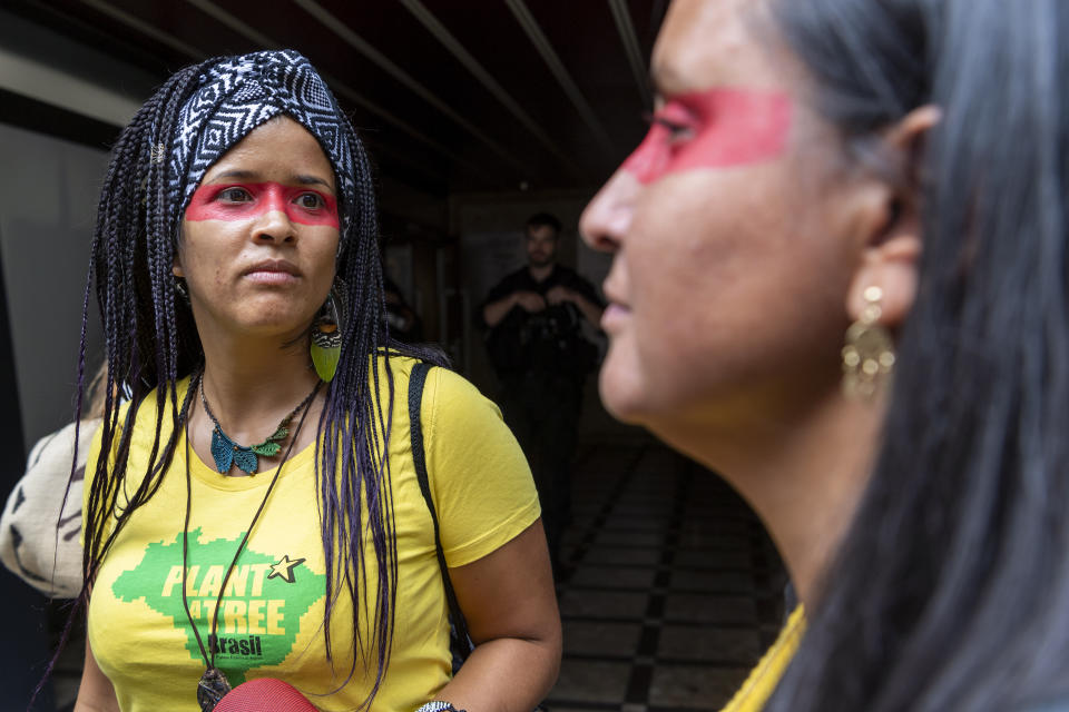 People protest in front of the Consulate General of Brazil in Geneva, Switzerland, Friday, Aug. 23, 2019 to denounce the words of President Bresil Jair Bolsonaro and the many fires in the forest Amazon. (Martial Trezzini/Keystone via AP)