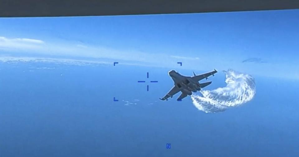 A Russian Su-27 fighter jet approaches a US military MQ-9 Reaper drone operating above the Black Sea on March 14, 2023.