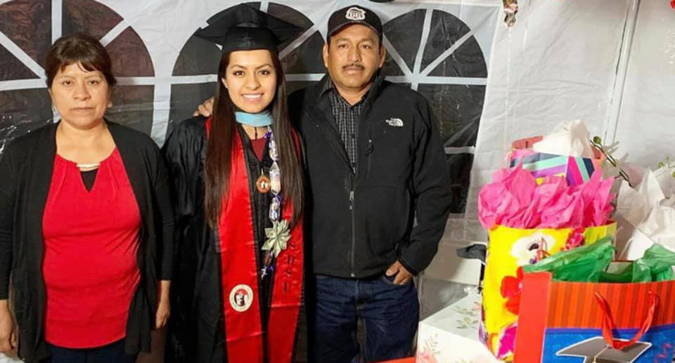 Erica Alfaro with her mother and father at her graduation celebration.