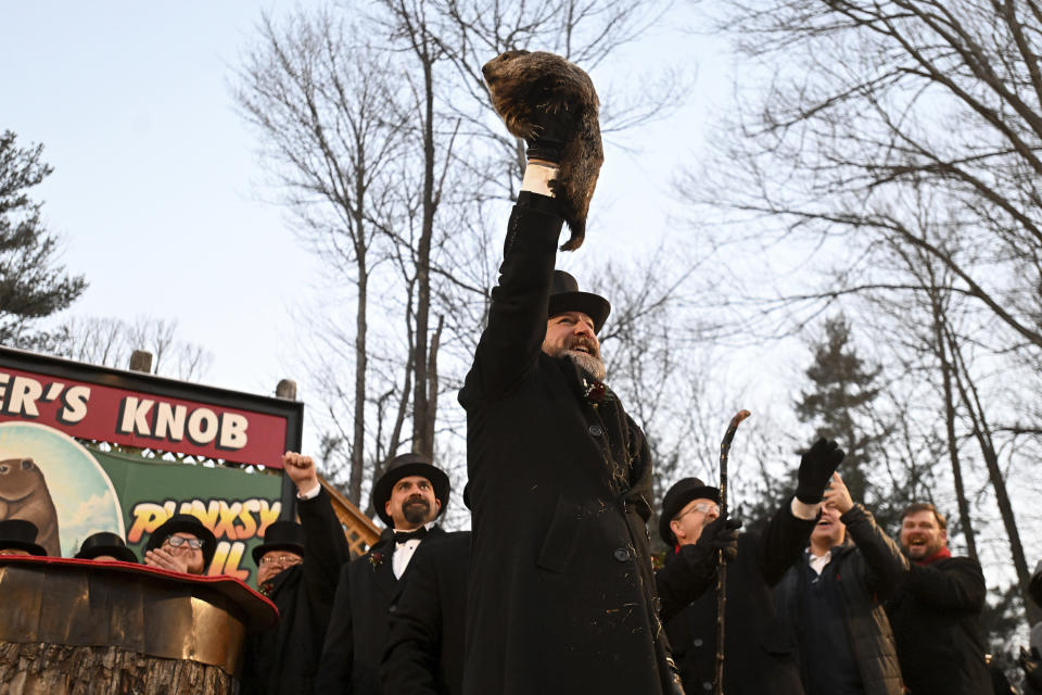 Groundhog Club handler A.J. Dereume holds Punxsutawney Phil, the weather prognosticating groundhog, during the 137th celebration of Groundhog Day on Gobbler's Knob in Punxsutawney, Pa., Thursday, Feb. 2, 2023. Phil's handlers said that the groundhog has forecast six more weeks of winter. (AP Photo/Barry Reeger)