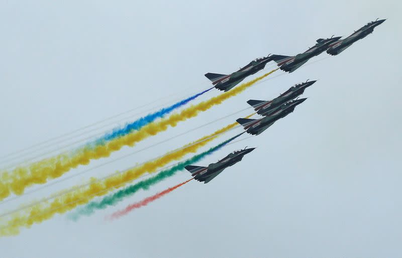 China's People's Liberation Army Air Force (PLAAF) Ba Yi aerobatics team perform an aerial display during a media preview of the Singapore Airshow in Singapore