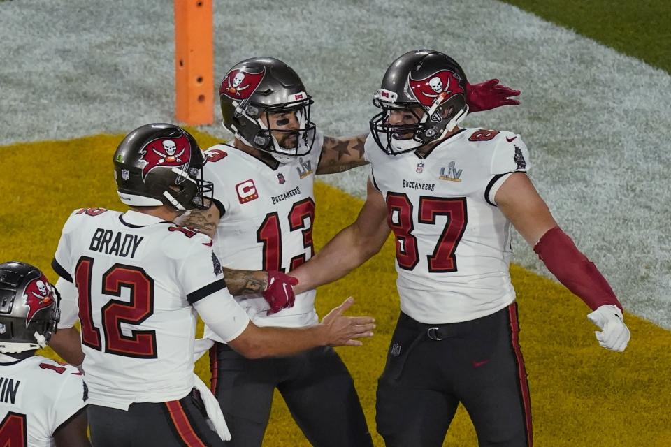 Tampa Bay Buccaneers quarterback Tom Brady (12) congratulates Rob Gronkowski (87) after a touchdown during Super Bowl LV on Sunday at Raymond James Stadium. (AP Photo/Charlie Riedel)