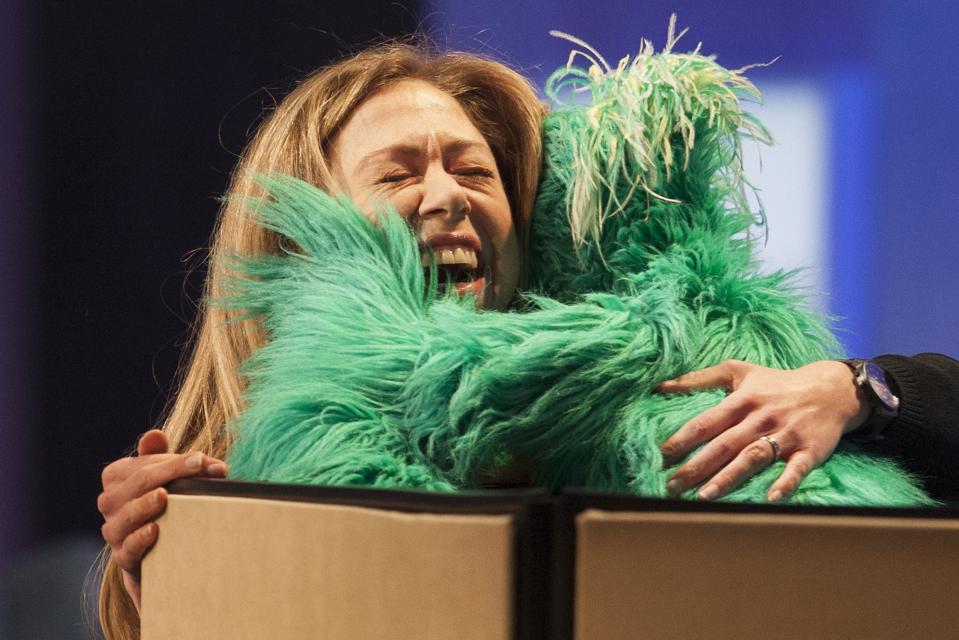 Chelsea Clinton, daughter of former U.S. President Bill Clinton, hugs "Rosita the Muppet" on stage during the Clinton Global Initiative 2013 (CGI) in New York September 24, 2013. REUTERS/Carlo Allegri (UNITED STATES - Tags: POLITICS TPX IMAGES OF THE DAY)