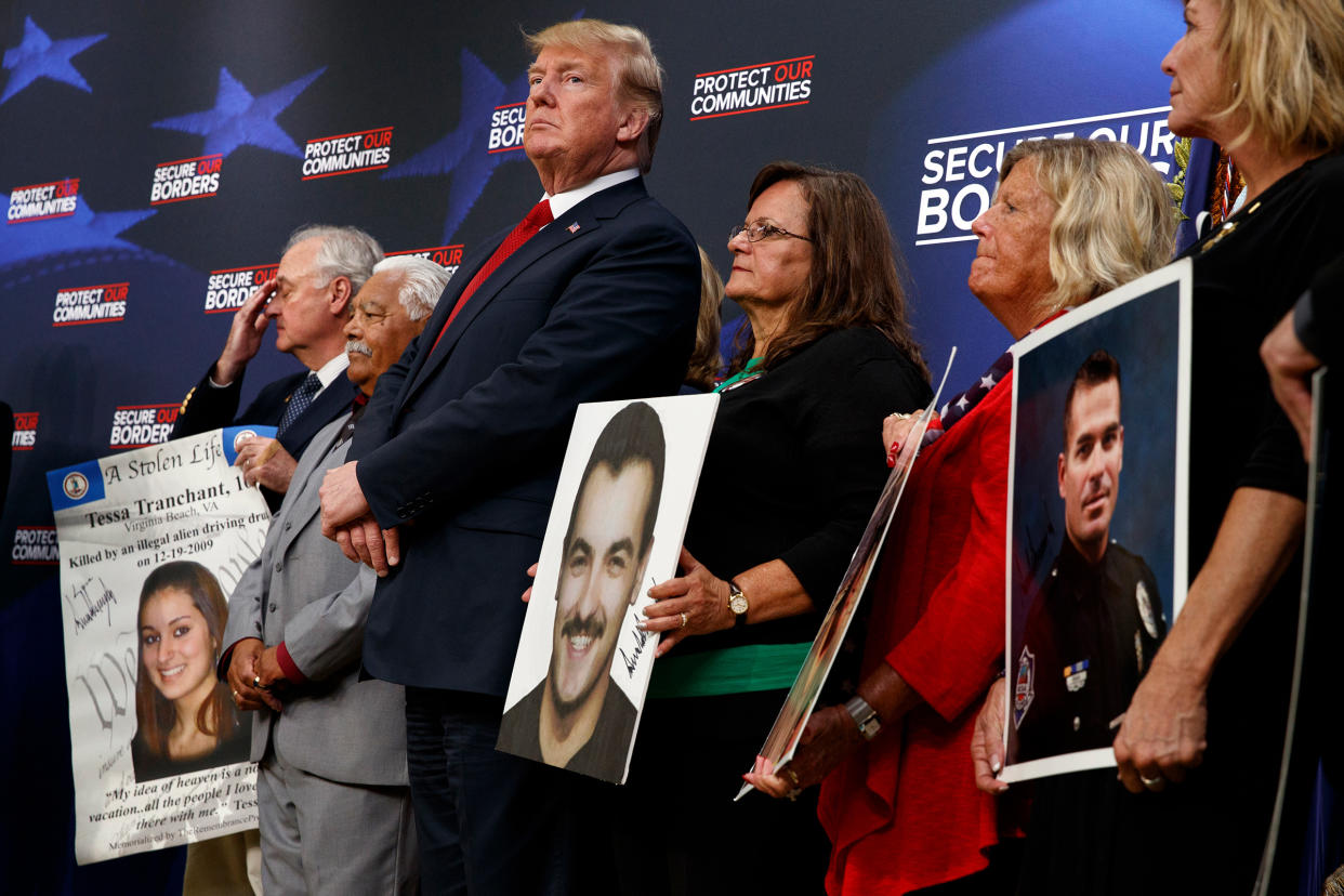 Former President Donald Trump stands alongside "angel families" at the White House complex on June 22, 2018.