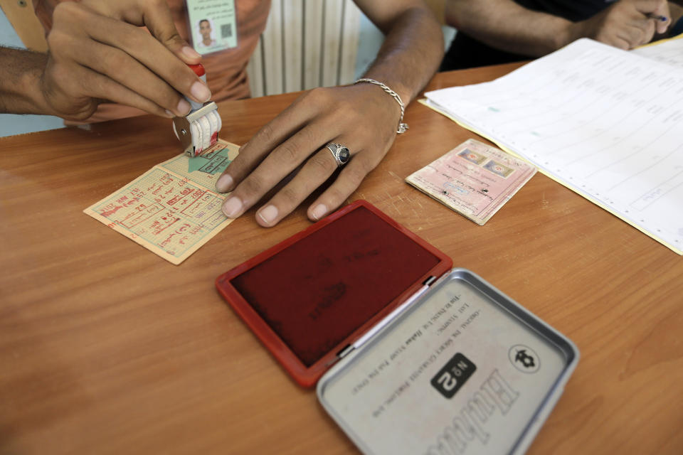 An election official works inside a polling station as Algerians cast their vote in the country's first legislative elections sine the ouster of ex-president Bouteflika, in Algiers, Algeria, Saturday, June 12, 2021. Algerians vote Saturday for a new parliament in an election with a majority of novice independent candidates running under new rules meant to satisfy demands of pro-democracy protesters and open the way to a "new Algeria." (AP Photo/Toufik Doudou)