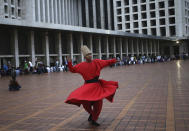 <p>A whirling dervish performs as Muslim men wait to break their fast at Istiqlal Mosque during the second day of Ramadan in Jakarta, Indonesia, Sunday, May 28, 2017. (AP Photo/Dita Alangkara) </p>