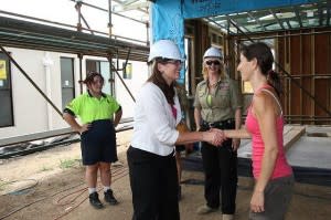 Some women standing in a half-built house