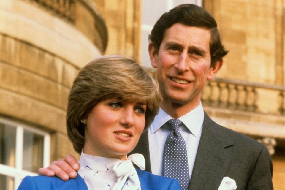 Charles and Diana in the grounds of Buckingham Palace in 1981 after announcing their engagement (PA)