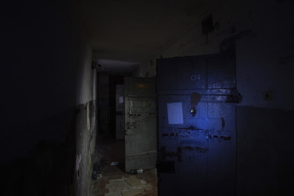 Jail cell doors open into a hallway in a police department in Izium, Ukraine, Thursday, Sept. 22, 2022. Ukrainian civilians said they were held and tortured at the site by Russian soldiers. (AP Photo/Evgeniy Maloletka)