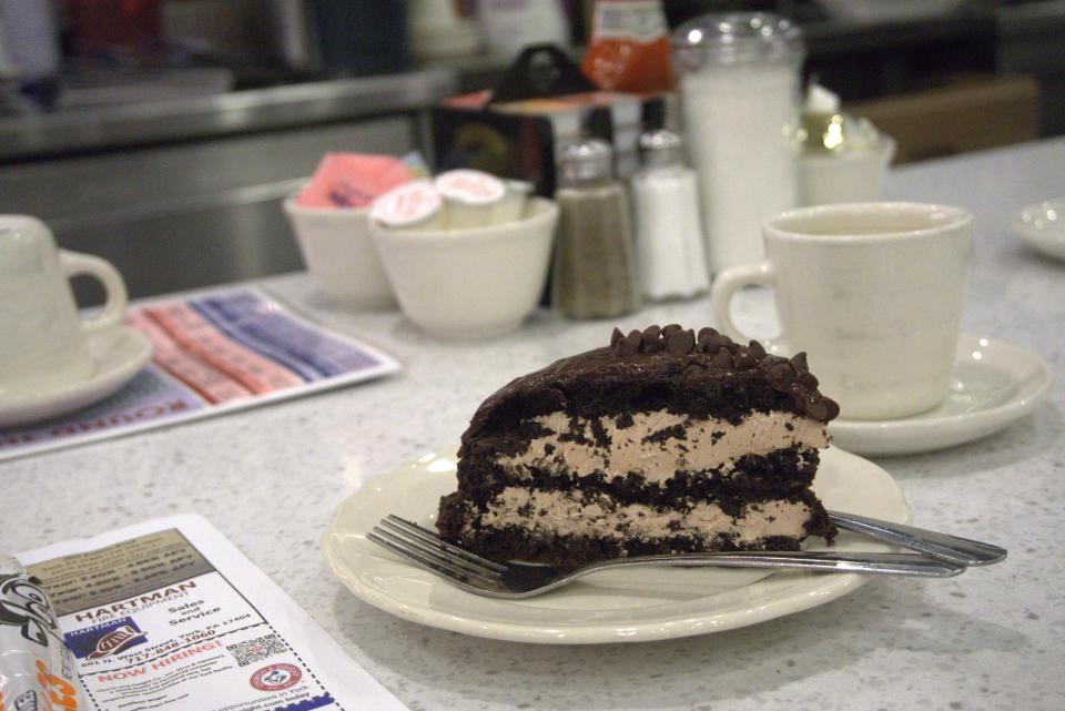 A slice of homemade double chocolate cake and a cup of piping hot decaf coffee - the perfect midnight treat - at Round the Clock Diner on Arsenal Road in York.