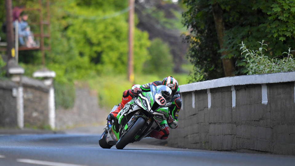 Racer Peter Hickman rides his BMW M 1000 RR on the way to victory at the 2022 Isle of Man TT.