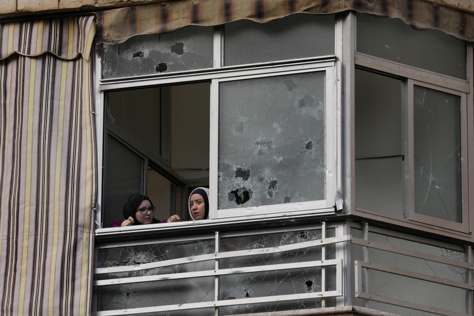 Lebanese women look through their damaged window house, near an apartment building where an apparent Israeli strike Tuesday killed top Hamas political leader Saleh Arouri, in the southern suburb of Beirut that is a Hezbollah stronghold, Lebanon, Wednesday, Jan. 3, 2024. The apparent Israeli strike that killed Hamas' No. 2 political leader, marking a potentially significant escalation of Israel's war against the militant group and heightening the risk of a wider Middle East conflict. (AP Photo/Hussein Malla)