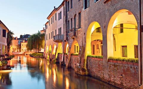 Treviso is a little walled city, with medieval gates, narrow, cobbled streets of arcaded rose-red brick and stone